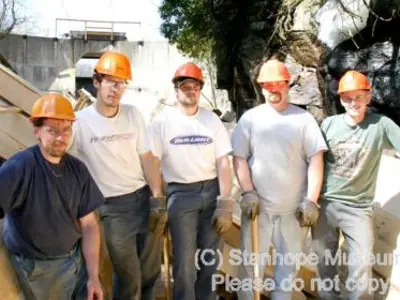 Image shows members of the construction team posing for a photo. 