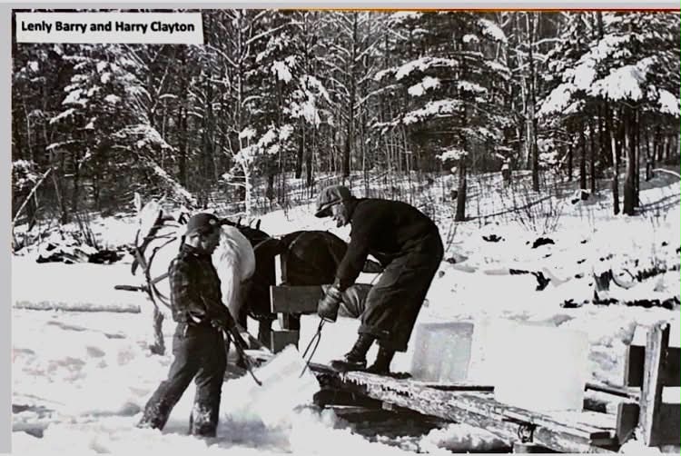 Image shows boys lifting a large block of ice.