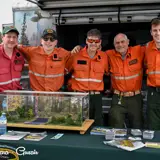 Image shows a group of MNRF firefighters at an information booth. 