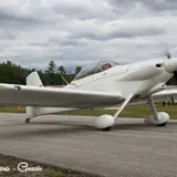 Image shows a white vintage plane on the taxiway. 