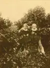 Image shows two girls standing outdoors. 