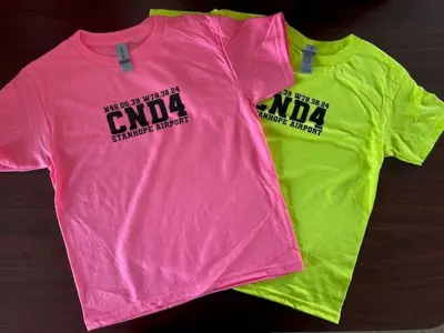 Image shows colourful T-shirts. 