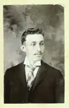 Image shows portrait of man in a suit. 