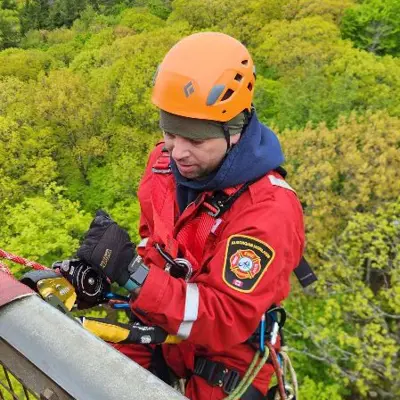 Image shows a firefighter scaling the Dorset Tower. 