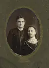 Image shows a portrait of two women in black dress. 