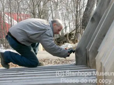 Image shows a man working on the frame of the new log chute. 