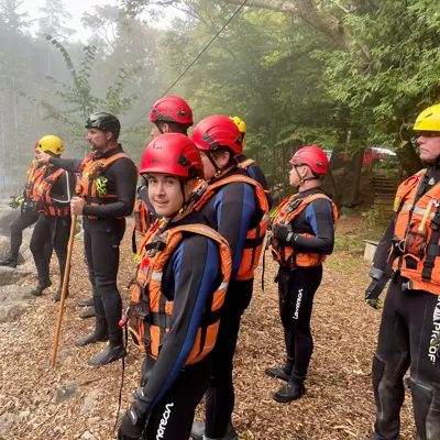 Image shows firefighters conducting swift-water training. 