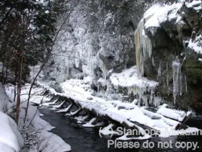 Image shows the Hawk Lake Log Chute covered in snow and ice. 