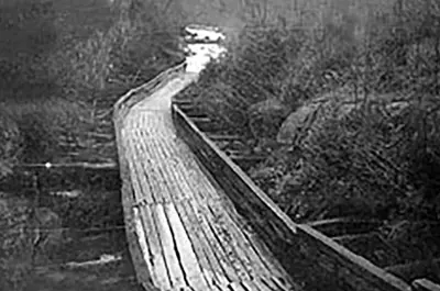 Image shows a black and white photo of the Hawk Lake Log Chute dating to 1920. 