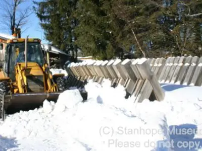 Image shows a backhoe helping to install the new log chute. 