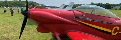 Image shows red airplane at fly-in. 