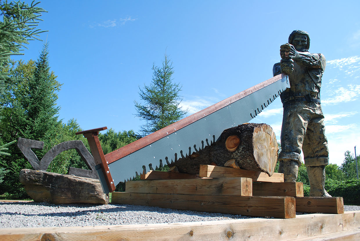 Image shows statue of a lumberjack. 